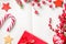 Christmas decorations, candy cane, frozen red berries, stars and gift box frame on notebook, copy space for text. Can be used for