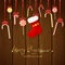 Christmas decorations with candy cane and sock on brown wooden b