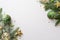 Christmas decorations concept. Top view photo of pine branches in snow with gold green transparent baubles star ornaments and