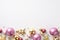 Christmas decorations concept. Top view photo of stylish gold violet and pink baubles star ornaments and confetti on isolated