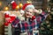 Christmas decorations and gift box on wooden background. Funny Laughing Surprised Woman Portrait. Emotions. Christmas