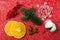 Christmas decorations lying on a red background with sequins. Snowflake, artificial berries, fir twig, cotton plant, anise stars