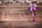 Christmas decorations. Purple bells and electrical garland on wooden background