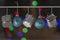 Christmas decorations in silver and blue, hanging from a bar, in