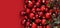 Christmas decorations, top view of pile of glass balls colored in red and mistletoe, isolated on red background, useful as a