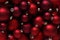 Christmas decorations, top view of pile of glass balls colored in red, useful as a greeting gift card background