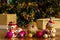 Christmas decorations-toys snowmen, Santa Claus and balloons lie on a wooden table. Boxes with gifts and green tinsel with