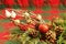 CHRISTMAS DECORATIONS, two white doves, gold jingle bells, pine cones, evergreen branches, red and green