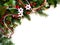 Christmas decorative background for greeting card, twigs of spruce and mistletoe with holly leaves and red balls, ribbon, cones