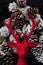 Christmas Decorative reindeer on red velvet background pinecone