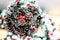 Christmas decorative softfocus background: artificial mistletoe ball of xmas tree branches and pinecones covered in snow