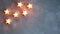 Christmas decorative stars candles glowing a light on grey texture background