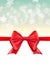 Christmas defocused bokeh background with red bow. Gift card holiday celebration invitation xmas