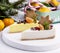 Christmas Dessert Two Slice of Cheesecakes Decorated with Citrus Gingerbread Star and Berries WoodenTray White Background Fir Bran