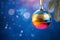 Christmas disco ball with bright ray lights and colorful bokeh on blue neon background