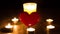 Christmas divination. Fortune telling. Divination for love. The red heart stands in the middle of the lighted candles. Ritual of