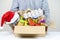 Christmas donation. Volunteer holding food donation box with grocery products