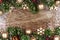 Christmas double border with gold ornaments, branches on rustic wood
