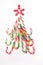 Christmas edible tree of multicolored sweet Christmas canes on white background