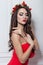 Christmas elegant fashion woman. Xmas New Year hairstyle and makeup. Gorgeous Vogue style Lady with Christmas decorations on her