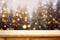 Christmas empty wooden table top for product placement, Christmas tree and pines with lights and snow falling blurred bokeh