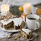 Christmas English fruitcake with candied fruit, dried fruit and nuts, decorated with white icing on a wooden background with fir b