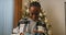 Christmas Eve. An African-looking girl received gift from family and decided to record video for them. Behind is