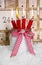 Christmas eve: four red burning candles with a shabby white advent calendar background