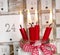 Christmas eve: four red burning candles with a shabby white advent calendar background