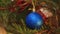 On Christmas evening, a blue ball hangs on the tree and sways.