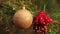 On Christmas evening, a golden ball hangs on a green tree.