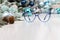 Christmas eyeglasses blue spectacles isolated on white table with balls and decorations useful as a greeting gift card template