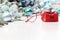 Christmas eyeglasses red spectacles near package with ribbon bow isolated on white table with balls and decorations useful as a