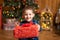 Christmas fabulous, little boy holding a big red box with a present from Santa