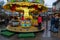 Christmas fair, small merry-go-round at evening. People have fun on small Christmas market in Ratingen, Germany.