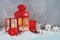 Christmas fairy composition of red lantern with Christmas tree and lights inside, decorative skis, sledges with