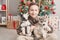 Christmas family. Child boy with dogs husky puppies on background of christmas tree. Happy New Year! Christmas greeting card with