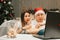 Christmas family couple, man and woman watch video movie on laptop at home, happy fun and cozy xmas holiday together