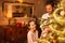 Christmas - father and daughter decorate christmas tree