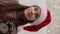 Christmas female portrait attractive young female red Santa hat pointing clock