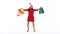 Christmas female shopper holding multicolored shopping bags and crazy dancing on white background in studio. Let`s go