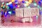 Christmas Festive Background. Toy car covered in snow carries boxes with gifts in the snow