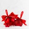 Christmas festive background in white and red color - group of red shimmer balls with satin ribbon, bows in snowdrift under white.