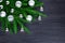 Christmas festive corner border, New Year decorative frame, shiny silver glass balls decorations on green fir branches on black