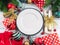 Christmas festive dinner table setting with decor and cutlery with golden bow, empty white dish