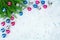 Christmas festive frame, New Year decorative corner border, shiny silver, pink, blue balls decorations, fir branches on light icy