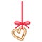 Christmas festive heart gingerbread cookie covered by white icing with red ribbon