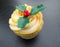 Christmas festive lemon cupcake with cream and holly leaves