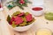 Christmas festive snacks. Green and Red Tortilla crisps chips in the shape of a Christmas tree in a white bowl with