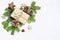 Christmas festive styled stock image composition. Handmade craft paper gift box, pine cones, wooden and anise stars and